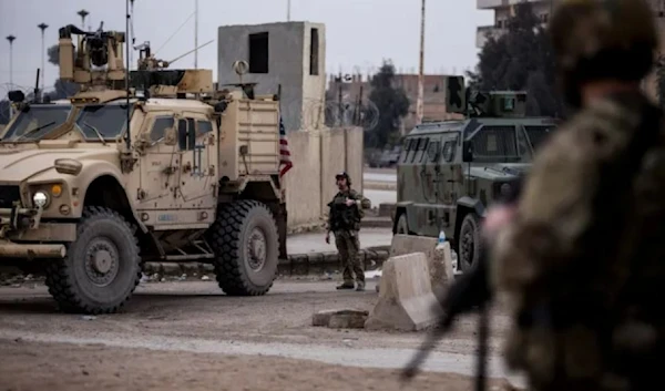 US occupation soldiers stand guard in northeast Syria, on January 27, 2022 (AP)