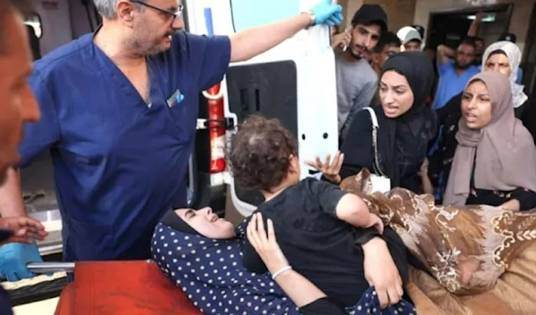 A wounded Palestinian woman and her child are wheeled into the Nasser hospital following Israeli bombardment, in Khan Younis, in the southern Gaza Strip on October 26 (AFP)