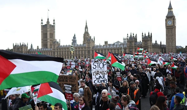 Pro-Palestinian, anti-Israel protesters walk over Westminster Bridge, near the Houses of Parliament, during a 'March For Palestine' in London on October 28, 2023. (AFP)