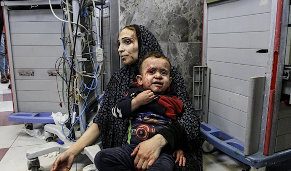 A woman and her child wounded in a hospital in Gaza (AP)