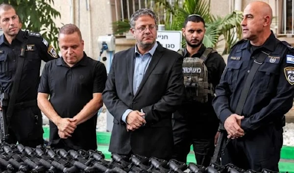 Israeli Occupation Police Minister, Itamar Ben-Gvir, distributing US rifles to settlers in the West Bank, (AFP via Getty Images)