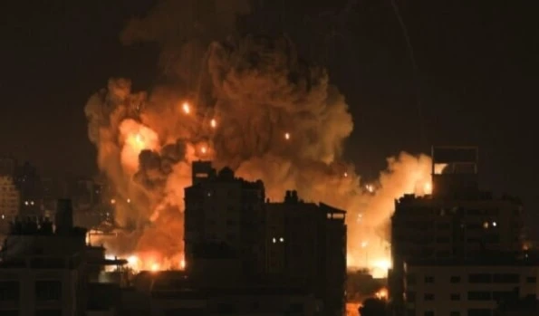 Fire and smoke rise above residential buildings in Gaza City during an Israeli airstrike on October 8, 2023 (AFP)