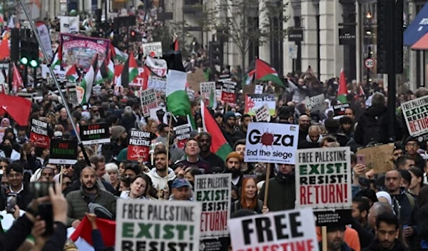 People walk down Regent Street as they take part in a 'March For Palestine' in London on October 14, 2023. (AFP)