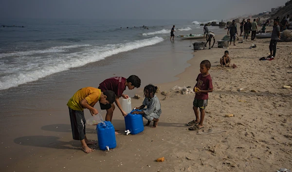 Palestinian children collect seawater at the beach in Deir al Balah, Gaza Strip, Thursday, Nov. 2, 2023. (AP)