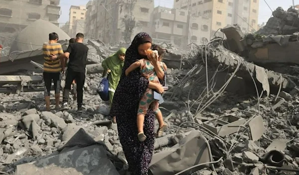 Palestinian mom holding her baby following an Israeli airstrike on the Sousi Mosque in Gaza on Oct. 9. (AFP via GETTY IMAGES)