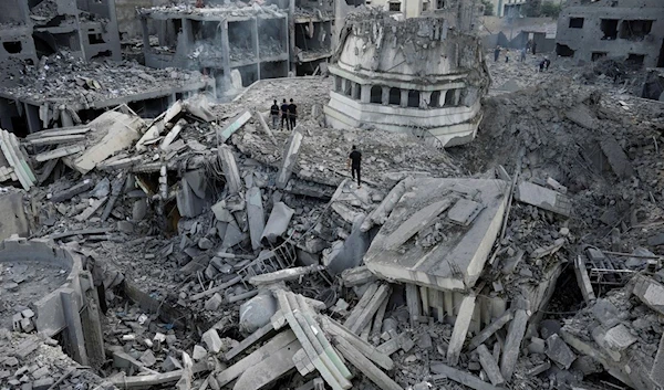 Palestinians inspect the rubble of the Yassin Mosque destroyed after it was hit by an Israeli airstrike at Shati refugee camp in Gaza City, early Monday, Oct. 9, 2023 (AP)