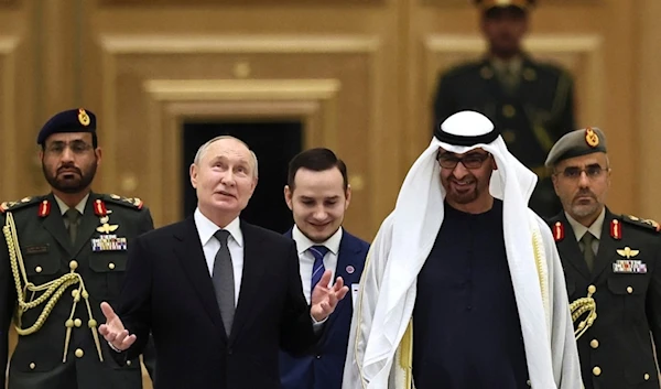 Emirati President Sheikh Mohammed bin Zayed Al Nahyan, foreground right, and Russian President Vladimir Putin, foreground left, attend an official welcome ceremony at Qasr Al Watan, Abu Dhabi, United Arab Emirates, Wednesday, Dec. 6, 2023 (AP)