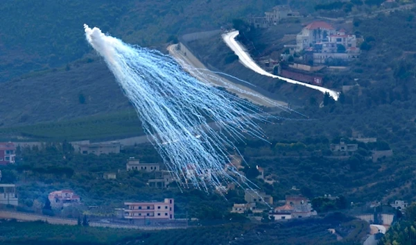 A white phosphorus shell from Israeli artillery explodes over Kfar Kila, a Lebanese border village with occupied Palestine, as it is seen from Marjayoun town in south Lebanon, November 22, 2023 (AP)