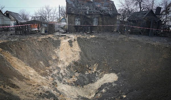 A general view of the crater at a site of recent missile attack in Kiev, Ukraine, Monday, Dec. 11, 2023. (AP Photo/Efrem Lukatsky)