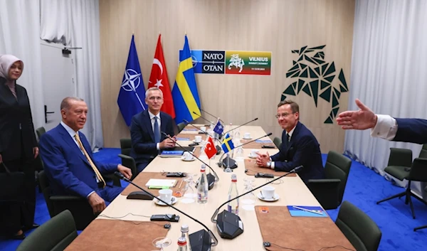 NATO Secretary General Jens Stoltenberg, center, Turkish President Recep Tayyip Erdogan, left, and Sweden's Prime Minister Ulf Kristersson, right, during a meeting ahead of a NATO summit in Vilnius, Lithuania, on July 10, 2023 (AP)