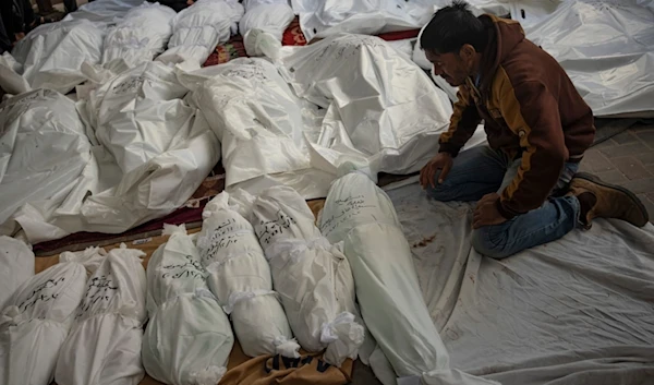 Palestinians mourn their relatives killed in the Israeli bombardment of the Gaza Strip, at the hospital Rafah, Gaza, Tuesday, Dec. 12, 2023. (AP Photo/Fatima Shbair)