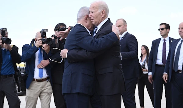 Israeli occupation’s Prime Minister Benjamin Netanyahu hugs US President Joe Biden upon his arrival at “Tel Aviv” on October 18, 2023.