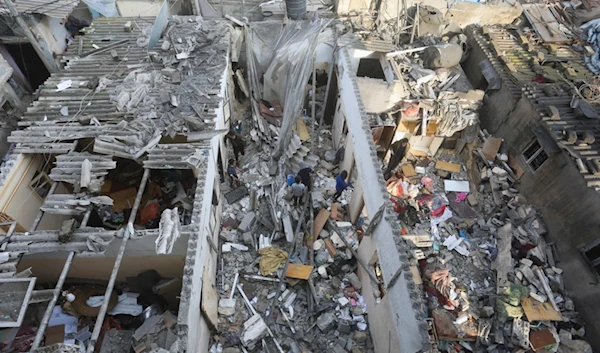 Palestinians salvage belongings after an Israeli air strike targeting residential buildings in Rafah, Gaza Strip, on Thursday, Dec. 14, 2023. (AP)