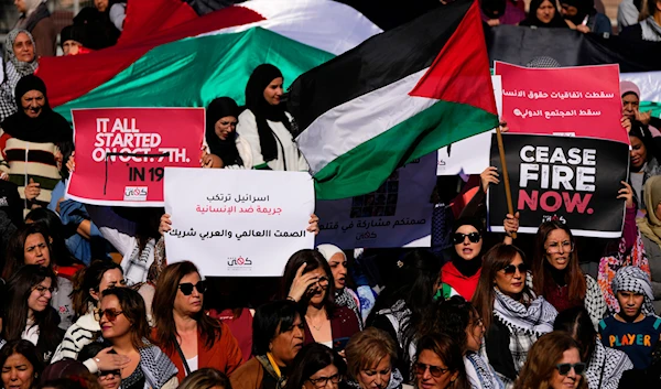 Protesters hold Palestinian flag during a protest in solidarity with the Palestinian people in Gaza, in front of the headquarters of U.N. Economic and Social Commission for Western Asia (ESCWA), in Beirut, Lebanon, Wednesday, Nov. 29, 2023. (AP)