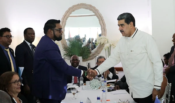 This handout picture released by the Venezuelan Presidency shows Venezuelas President Nicolas Maduro with Guyana’s President Irfaan Ali in Saint Vincent and The Grenadines on Dec. 14, 2023. (AFP)