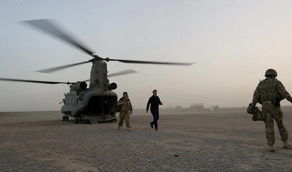 British Prime Minister David Cameron, centre, arrives at the Helmand Police Training Centre in Afghanistan Monday Dec. 6, 2010. (AP)