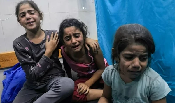 Palestinian children injured in an Israeli airstrike await treatment at a hospital in southern Gaza on October 17, 2023. (AFP)