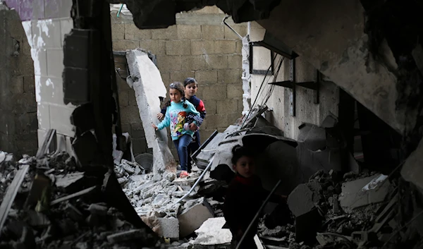 Palestinian children walk after an Israeli strike on residential buildings in Rafah, Gaza Strip, on Thursday, Dec. 14, 2023. (AP)