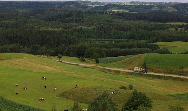 A farmer drives on a road, Poland, Thursday, July 7, 2022 (AP)