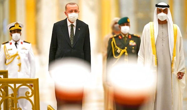 Turkish President Recep Tayyip Erdogan, center left, and Abu Dhabi Crown Prince Sheikh Mohammed bin Zayed Al Nahyan, right, stand for an honor guard at Qasr Al-Watan in Abu Dhabi, United Arab Emirates, Monday, Feb. 14, 2022. (AP)