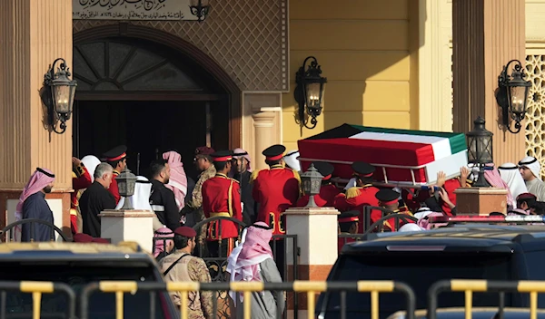 The coffin of the Emir of Kuwait Sheikh Nawaf Al Ahmad Al Sabah is being carried during his funeral at the Bilal bin Rabah Mosque in Kuwait, Sunday, Dec. 17, 2023. (AP)