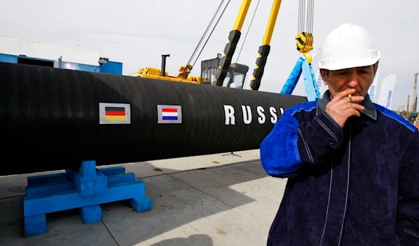 A Russian construction worker smokes in Portovaya Bay some 170 kms (106 miles) north-west from St. Petersburg, Russia, on April 9, 2010, during a ceremony marking the start of Nord Stream pipeline construction (AP)