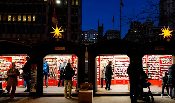 Shoppers visit the Christmas Village in Philadelphia, Wednesday, Dec. 13, 2023 (AP Photo/Matt Rourke)