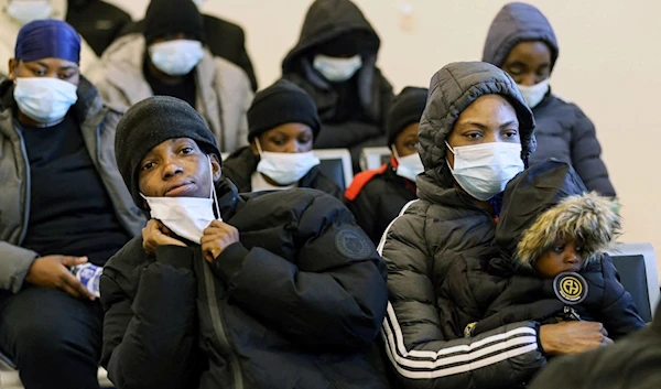 Nigerian migrants await processing during a deportation operation by the Tripoli-based government in the Libyan capital on December 12, 2023 (AFP)