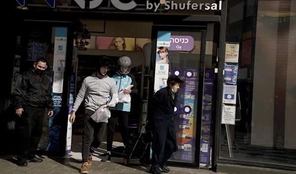 Delivery drivers from the Wolt app leave a pharmacy with rapid antigen tests for the coronavirus for delivery to customers in Occupied Palestine, Monday, Jan. 10, 2022.