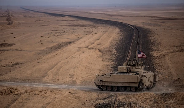 American soldiers drive a Bradley fighting vehicle during a joint exercise with Syrian Democratic Forces in the countryside of Deir Ezzor in northeastern Syria, Wednesday, Dec. 8, 2021 (AP)