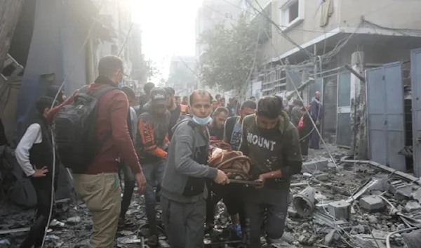 Palestinians evacuate their neighbors, family members who were injured or killed in Israeli bombardment in Rafah, Gaza Strip, December 1, 2023 (AP)