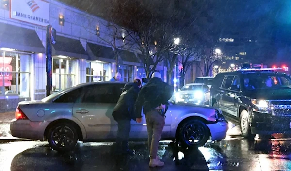 Agents surrounding a car that hit a motorcade vehicle as President Biden was leaving his campaign headquarters in Wilmington, Del., on December 17. (AFP via Getty Images)