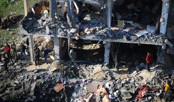 Palestinians view the destruction of their homes after an Israeli bombardment in Rafah, the Gaza Strip (AP)