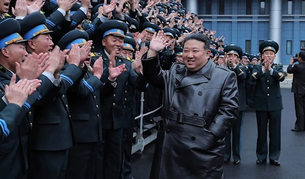 Kim Jong Un greets workers at the National Aerospace Techonology Administration (NATA) following successful launch of a reconnaissance satellite on November 23, 2023. (AP)