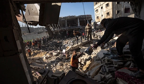 Palestinians search for bodies and survivors in the rubble of a residential building destroyed in an Israeli airstrike, in Rafah, southern Gaza Strip, Tuesday, Dec. 19, 2023 (AP Photo/Fatima Shbair)