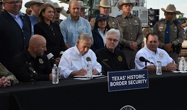 Gov. Greg Abbott signs three bills into law at a border wall construction site in Brownsville, Texas on Monday, Dec. 18, 2023, that will broaden his border security plans and add funding for more infrastructure to deter illegal immigration. (AP)