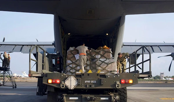 Photo provided by the Combined Joint Task Force-Horn of Africa and US Air Force, US Airmen load pallets onto a US C-130J Super Hercules bound for Somalia at Camp Lemonnier, Djibouti Tuesday, Oct. 17, 2017. (AP)