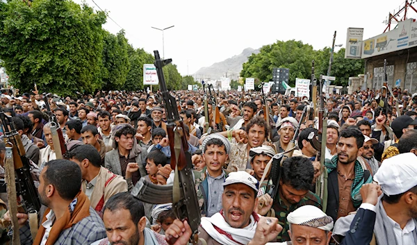 Houthi supporters chant slogans as they attend a rally marking eight years for a Saudi-led coalition, on March 26, 2023, in Sanaa, Yemen. (AP)