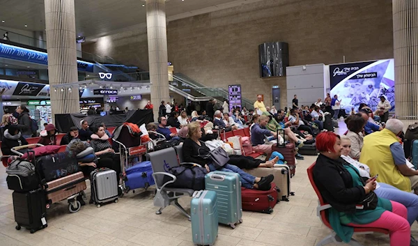 Passengers wait at Ben Gurion Airport near 'Tel Aviv', occupied Palestine, on October 7, 2023, as flights are canceled because of the launch of Operation Al Aqsa Flood. (AFP)