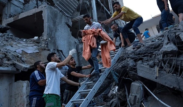 Palestinians rescue a young girl from the rubble of a destroyed residential building following an Israeli strike on Gaza, October 10, 2023 (AP)