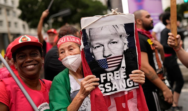 A demonstrator with a sign of Julian Assange protests his extradition to the U.S. in Rio de Janeiro, Brazil, Thursday, Sept. 7, 2023. (AP)