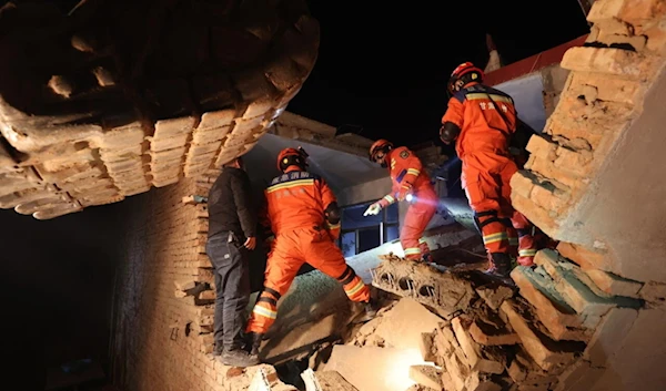 Rescue workers search a house for survivors after an earthquake in Kangdiao village, Dahejia, Jishishan County, in northwest China's Gansu province on December 19, 2023. (AFP)