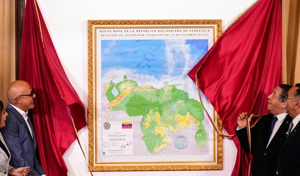 National Assembly President Jorge Rodriguez, and Chairman of the Special Commission for the Defense of Guyana Essequibo Hermann Escarra, unveil Venezuela's new map that includes the Essequibo territory, in Caracas, Venezuela, Friday, Dec. 8, 2023. (AP)