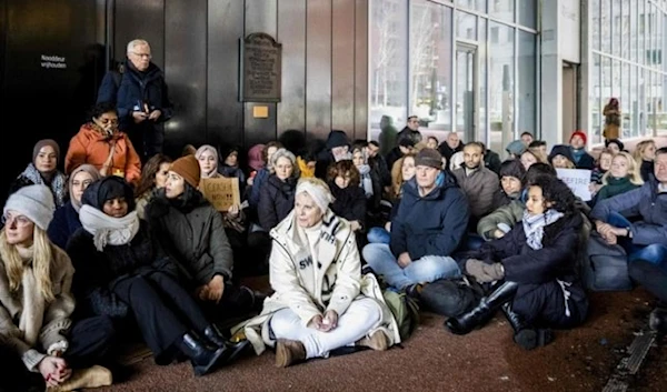 Government officials take part in a sit-in at the Ministry of Foreign Affairs in protest to the attitude of the outgoing cabinet regarding the Israeli aggression on Gaza, in The Hague on Dec. 21, 2023. (AFP)