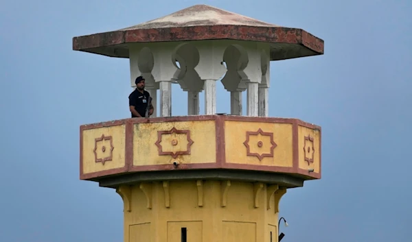 A police officer stands guard on a watch tower of district prison Attock, where Pakistan's former Prime Minister Imran Khan in-prison after his conviction, in Attock, Pakistan, Sunday, Aug. 6, 2023.