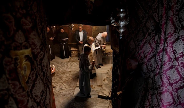 Latin clergies pray at the Grotto, under the Church of the Nativity, traditionally believed to be the birthplace of Jesus Christ in the West Bank town of Bethlehem, Tuesday Dec. 19, 2023 (AP)