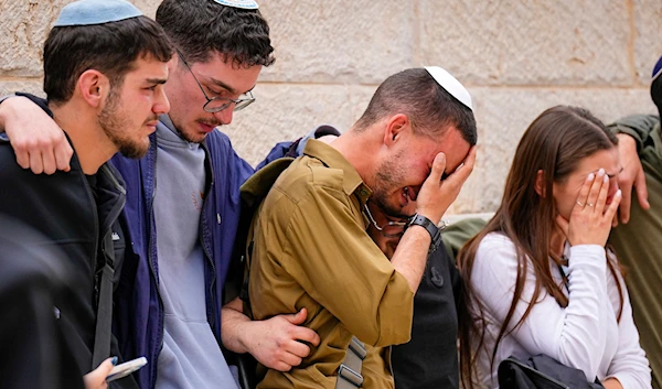 Friends of Israeli soldier Sergeant Lavi Ghasi mourn during his funeral in Modiin, Israel,Thursday, Dec. 21, 2023. (AP)