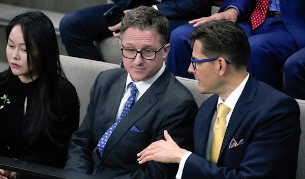 Canadians Michael Kovrig, right, and Michael Spavor, second from left, talk before an address from President Joe Biden in the Canadian House of Commons on March 24, 2023, in Ottawa, Canada. (AP)