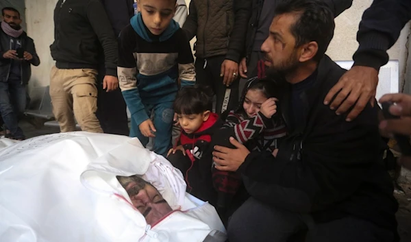 Relatives mourn Adel Zorob, a Palestinian freelance journalist who was killed with his family in the Israeli bombardment of the Gaza Strip outside a morgue in Rafah, Tuesday, Dec. 19, 2023. (AP)