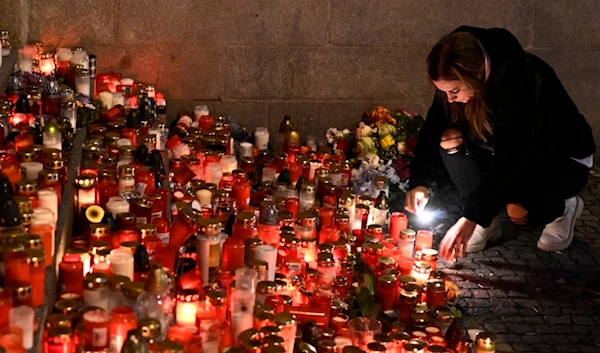 Mourners bring flowers and candles outside the building of Philosophical Faculty of Charles University in downtown Prague, Czech Republic, Saturday, Dec. 23, 2023. (AP)